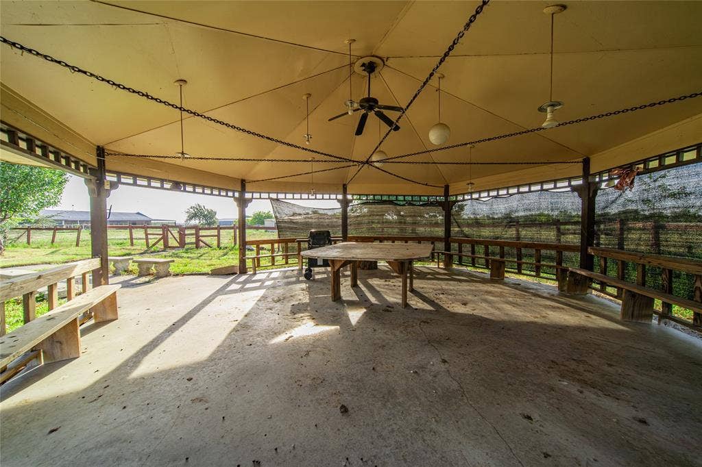 4320 Hickox Road, Rowlett, TX 75089 Expansive outdoor pavilion with a concrete floor, equipped with ceiling fans and mounted lighting fixtures