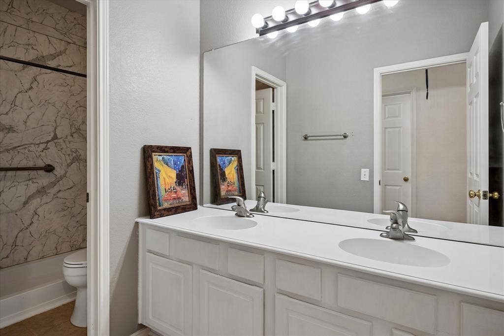 11379 Lockshire Drive, Frisco, TX 75035 Dual vanity with white cabinetry and built-in sinks