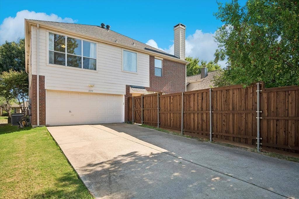 11379 Lockshire Drive, Frisco, TX 75035 Two-story exterior with brick and siding facade, an attached garage, and a concrete driveway