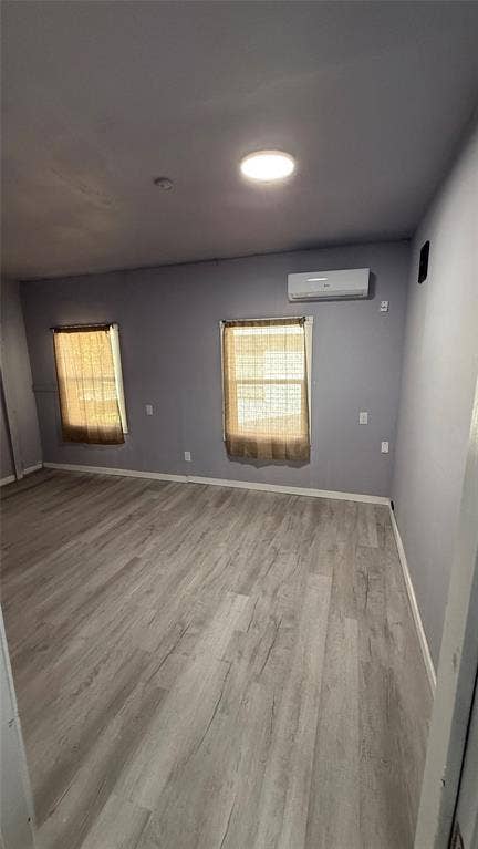 605 Biggs Terrace, Arlington, TX 76010 Wood-finish flooring, recessed ceiling lighting, and a wall-mounted climate control unit