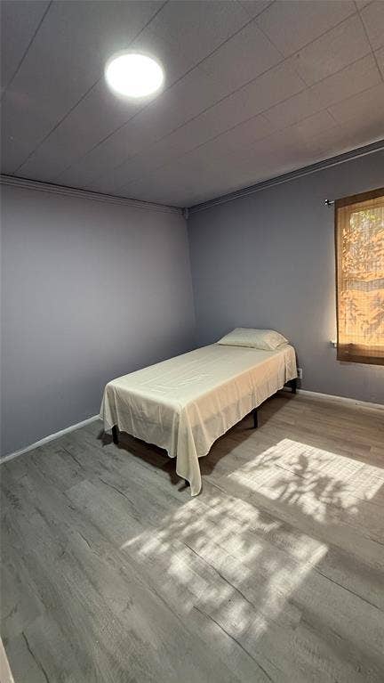 605 Biggs Terrace, Arlington, TX 76010 Wood-finish flooring with light gray walls and a ceiling-mounted light fixture