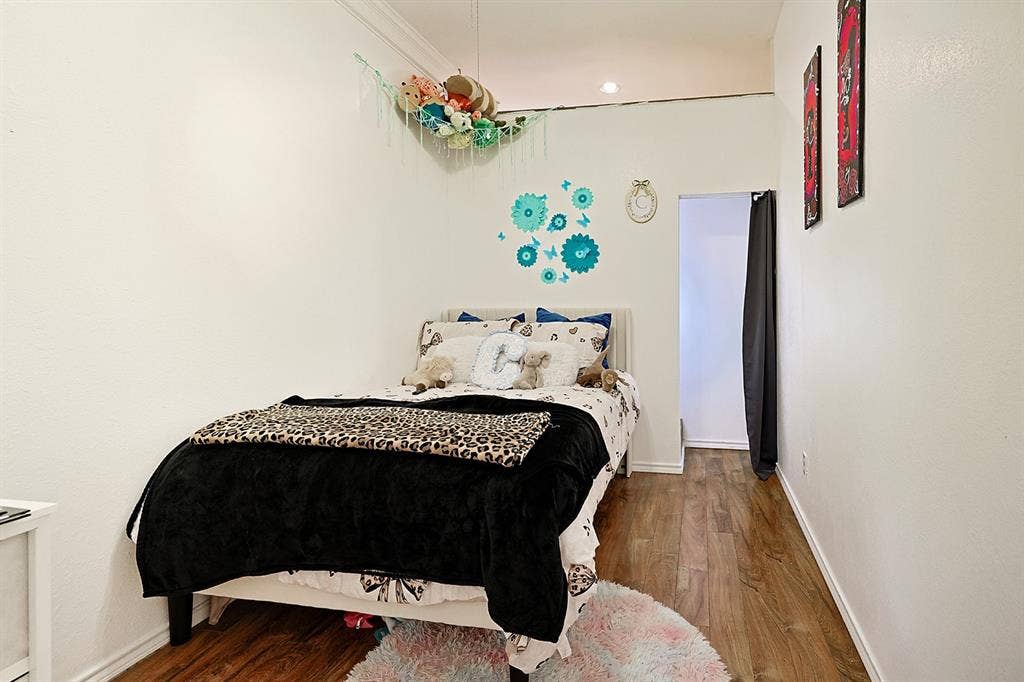 2042 County Road 1072, Greenville, TX 75401 Room featuring wood-finish flooring, smooth white walls, and crown molding