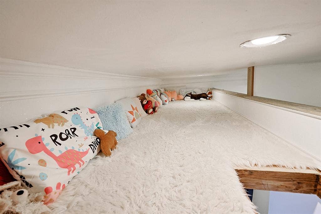 2042 County Road 1072, Greenville, TX 75401 Elevated loft area featuring white wall paneling, a recessed ceiling light, and wooden structural trim