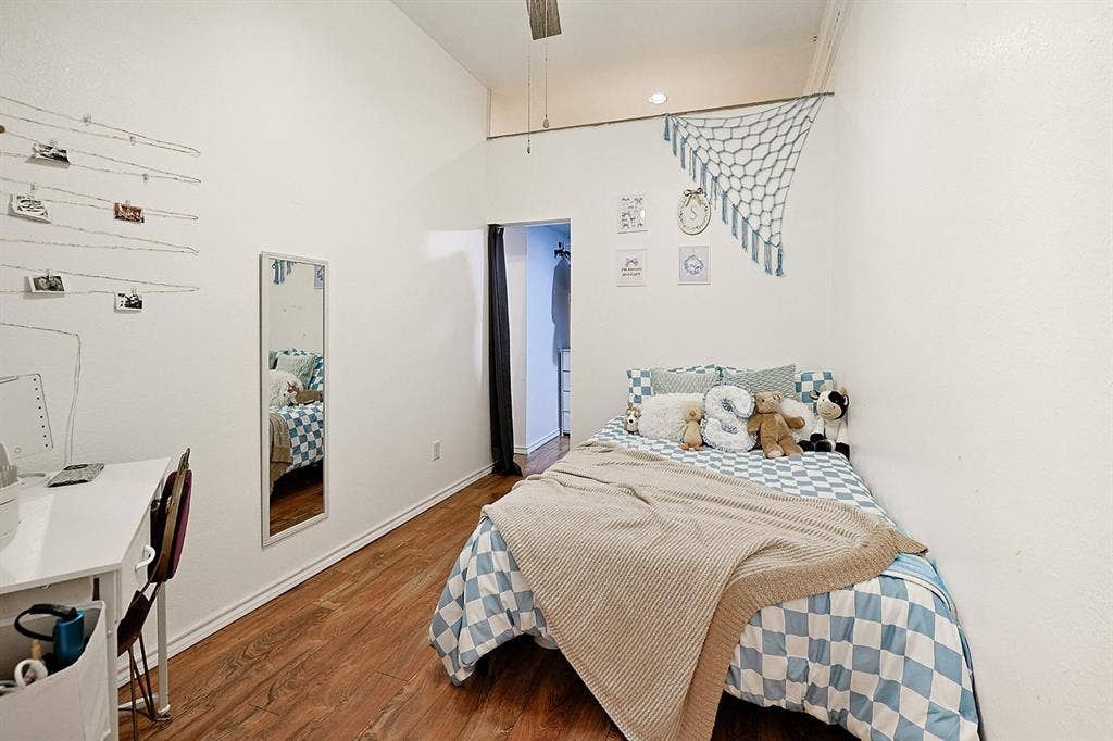 2042 County Road 1072, Greenville, TX 75401 Vaulted ceilings, wood-finish flooring, and wall-mounted full-length mirror