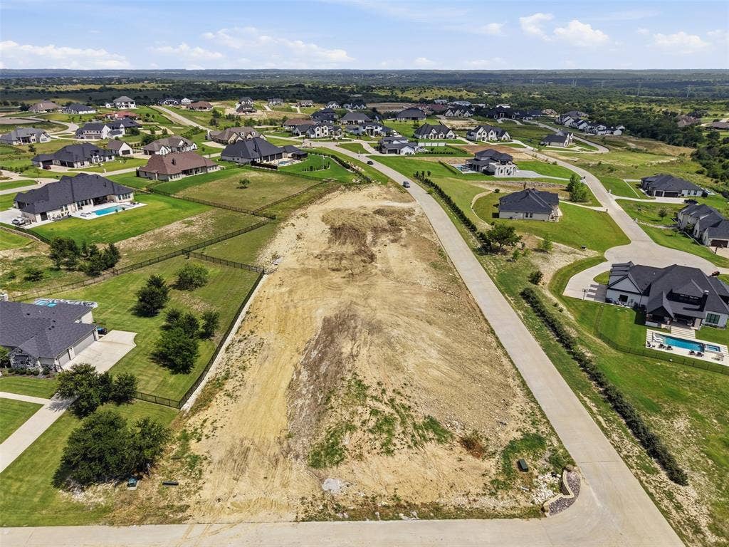 12300 Bella Quinn Drive, Fort Worth, TX 76126 Expansive vacant lot with street frontage, surrounded by established residences, and featuring a partially cleared terrain