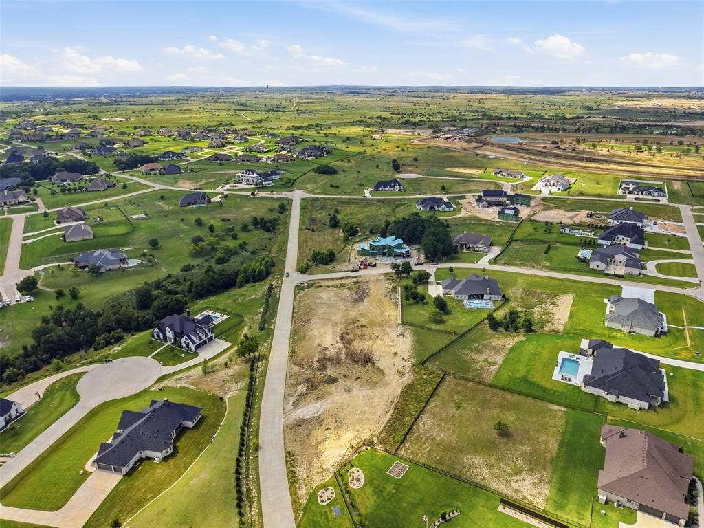 12300 Bella Quinn Drive, Fort Worth, TX 76126 Expansive lot within a developed residential community, featuring paved roadways and surrounding properties with private swimming pools