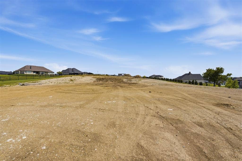 12300 Bella Quinn Drive, Fort Worth, TX 76126 Expansive land parcel with graded terrain, surrounded by a developing residential area