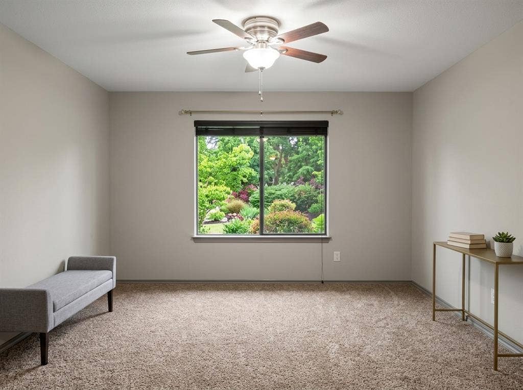 2500 Sierra Drive, McKinney, TX 75071 Plush carpet flooring, neutral wall tones, window with a lush green backdrop, and a ceiling fan with integrated lighting