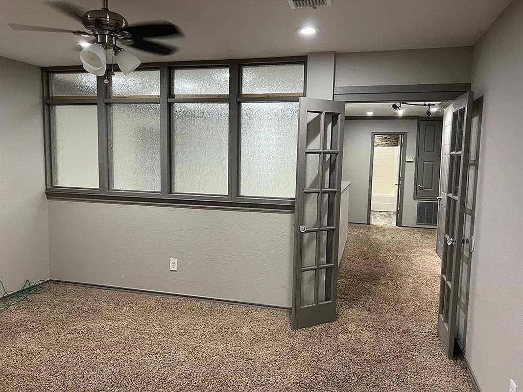 2500 Sierra Drive, McKinney, TX 75071 Carpeted interior with a ceiling fan, transom windows, and French doors leading to an additional space