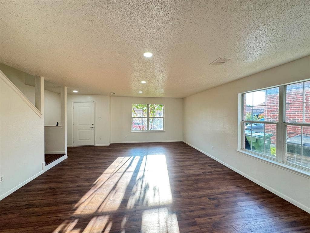 7305 Marsland Lane, Arlington, TX 76001 Spacious open-concept room featuring wood-finish flooring, recessed lighting, and multiple windows