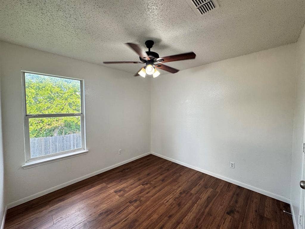 7305 Marsland Lane, Arlington, TX 76001 Bedroom featuring wood-finish flooring, white walls, and a ceiling fan with integrated lighting