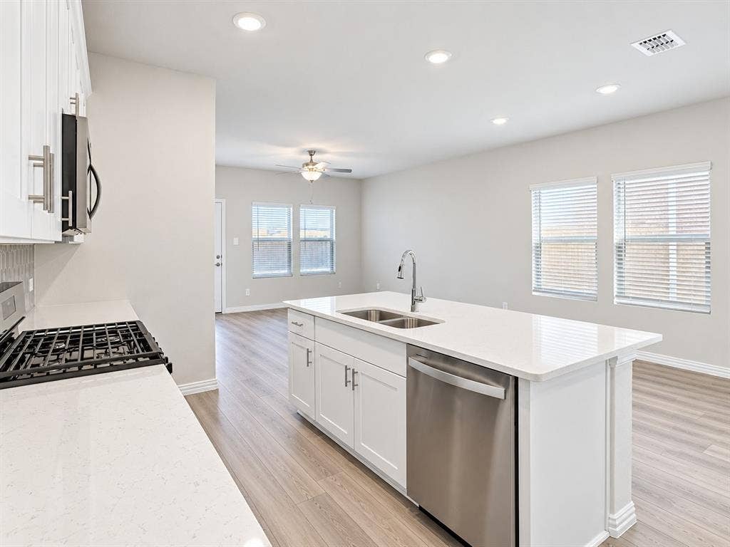 5204 Golden Trout Drive, Princeton, TX 75071 Kitchen island with a double basin sink and stainless steel dishwasher