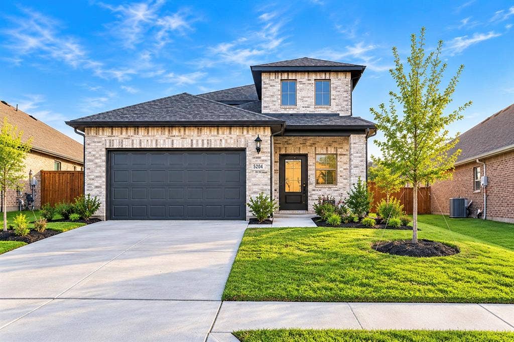 5204 Golden Trout Drive, Princeton, TX 75071 Brick veneer exterior with dark shingle roof and covered entry