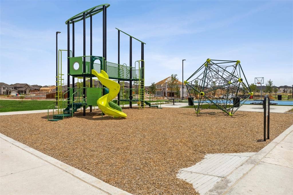 5204 Golden Trout Drive, Princeton, TX 75071 Community playground featuring a multi-level structure with a spiral slide, a rope climbing dome, and a basketball court