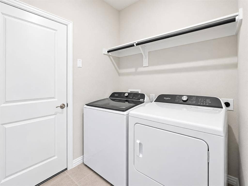 5204 Golden Trout Drive, Princeton, TX 75071 Laundry area with a white paneled door, light-toned wall paint, and tile flooring