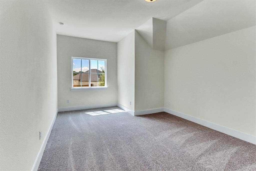 115 Cottonwood Court, Murphy, TX 75094 Neutral-toned wall finish, framed window, textured carpeting, and white baseboards