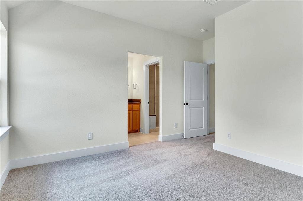 115 Cottonwood Court, Murphy, TX 75094 Plush carpeting, neutral wall tones, and white trim