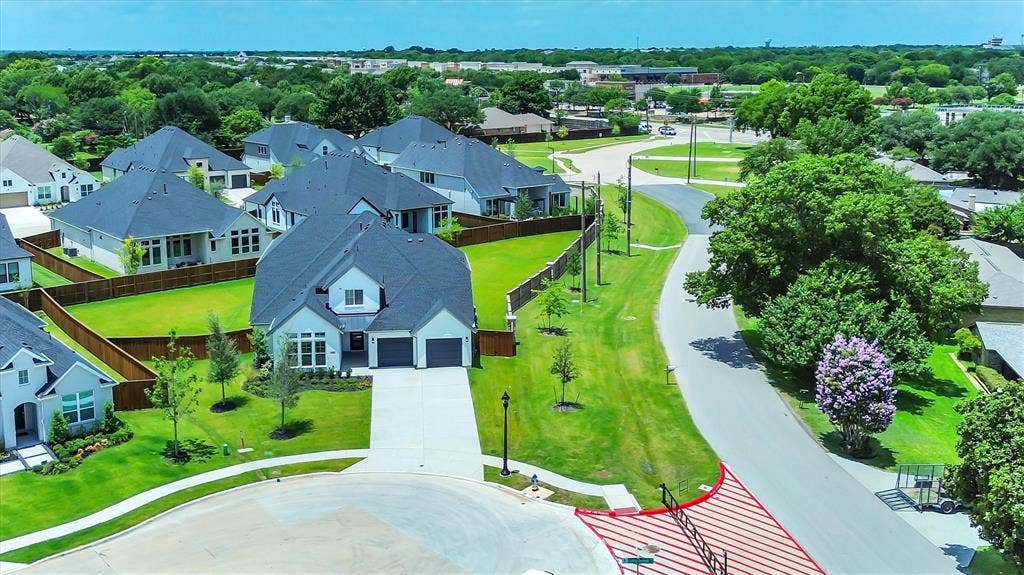 115 Cottonwood Court, Murphy, TX 75094 Contemporary residence with an attached two-car garage, concrete driveway, and established landscaping