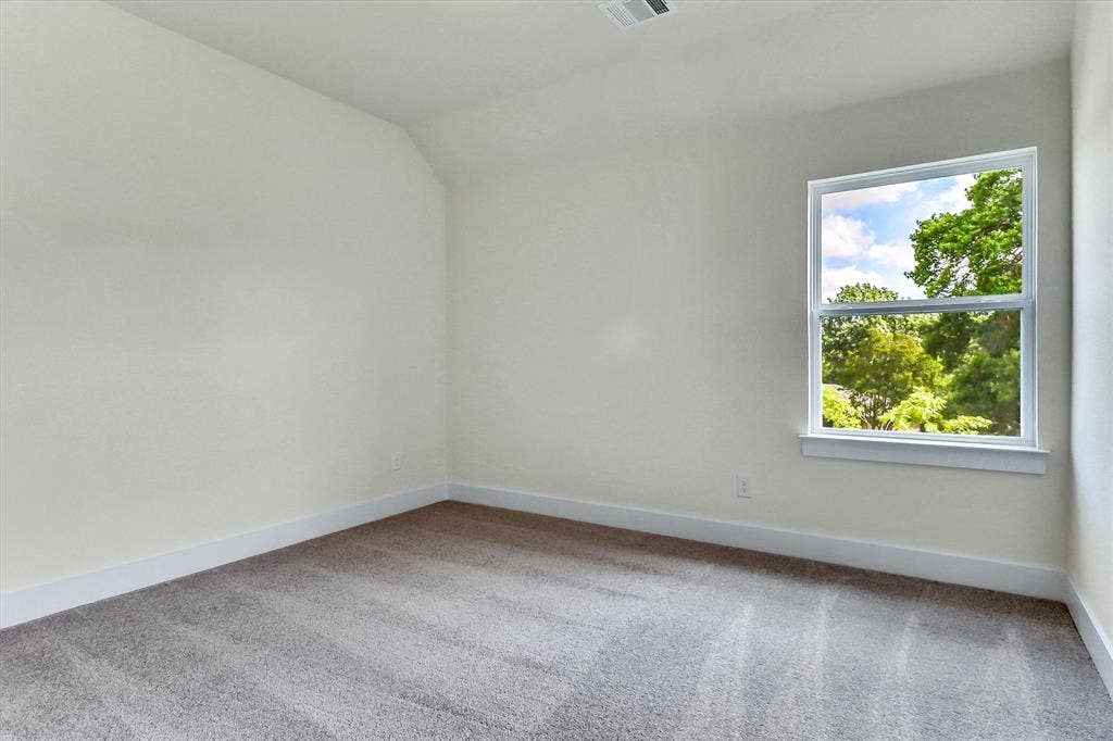 115 Cottonwood Court, Murphy, TX 75094 Neutral wall paint with textured carpeting and a white trim baseboard