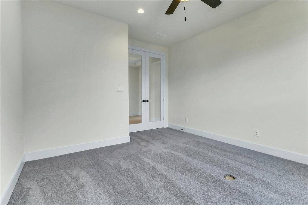 115 Cottonwood Court, Murphy, TX 75094 Light gray carpeting with recessed lighting and a ceiling fan