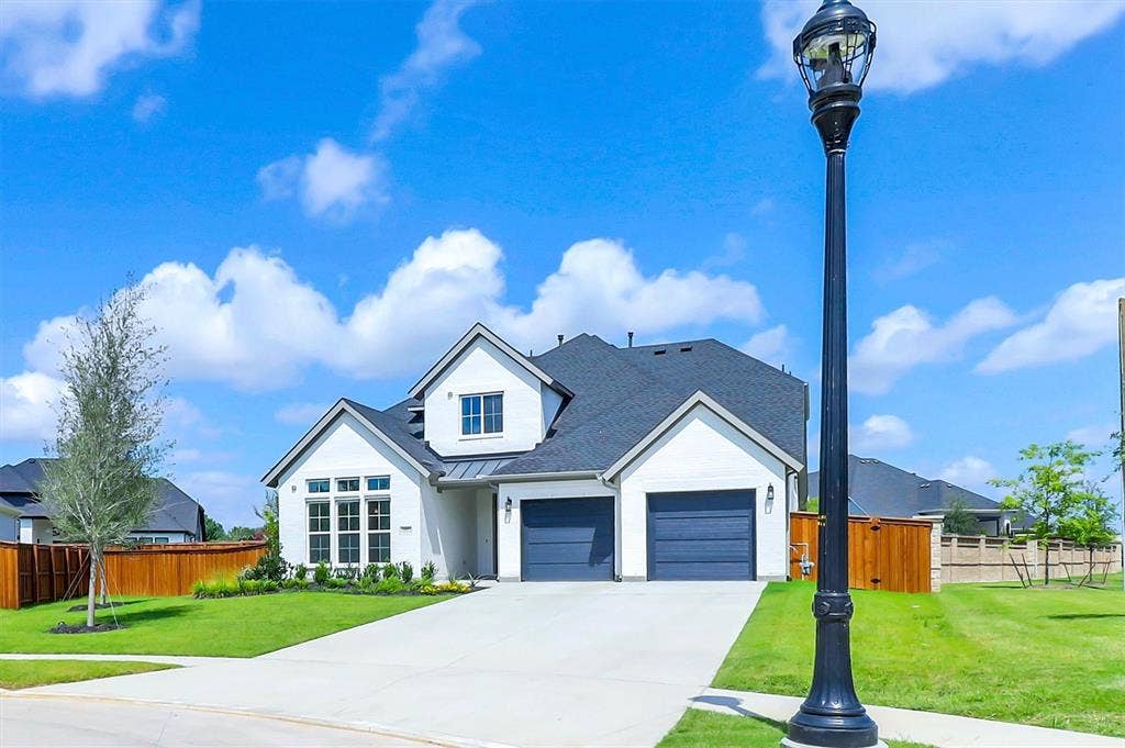 115 Cottonwood Court, Murphy, TX 75094 Modern farmhouse exterior with white siding and dark gray garage doors