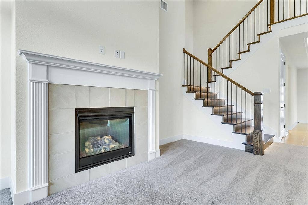 115 Cottonwood Court, Murphy, TX 75094 Fireplace with a tile surround and substantial mantel