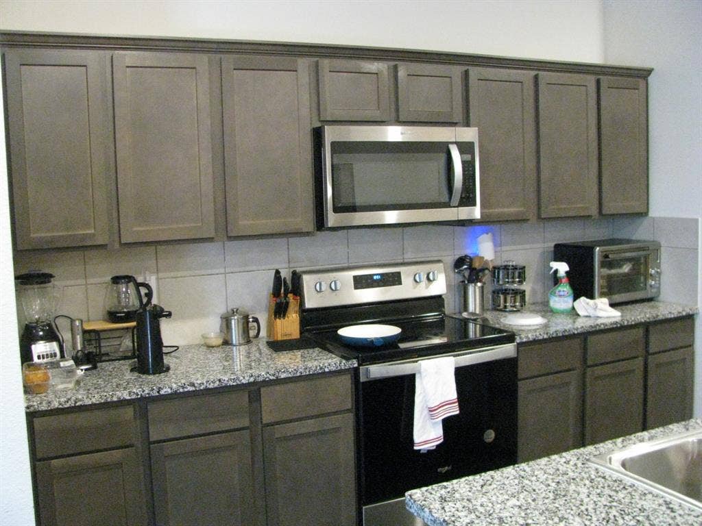 1322 Bushel Drive, Royse City, TX 75189 Beautiful cabinetry, granite countertops and a built-in microwave.