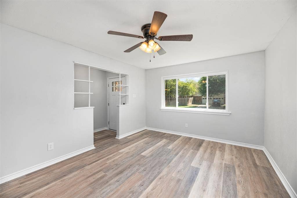 Wood-finish flooring throughout, complemented by a ceiling fan with integrated lighting