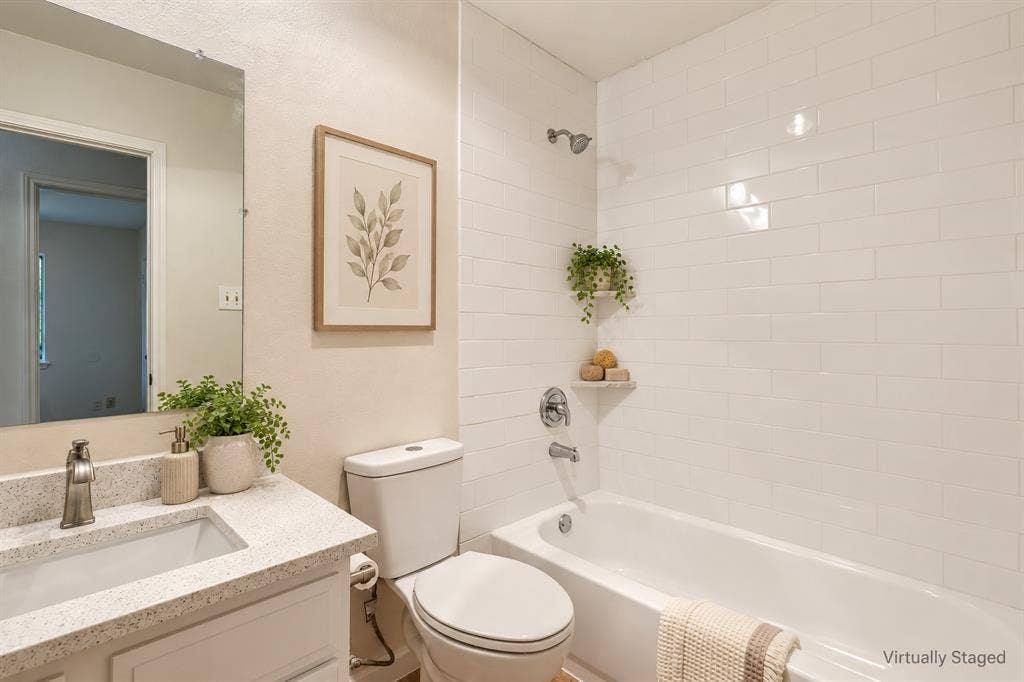 White subway tile shower surround with a built-in tub