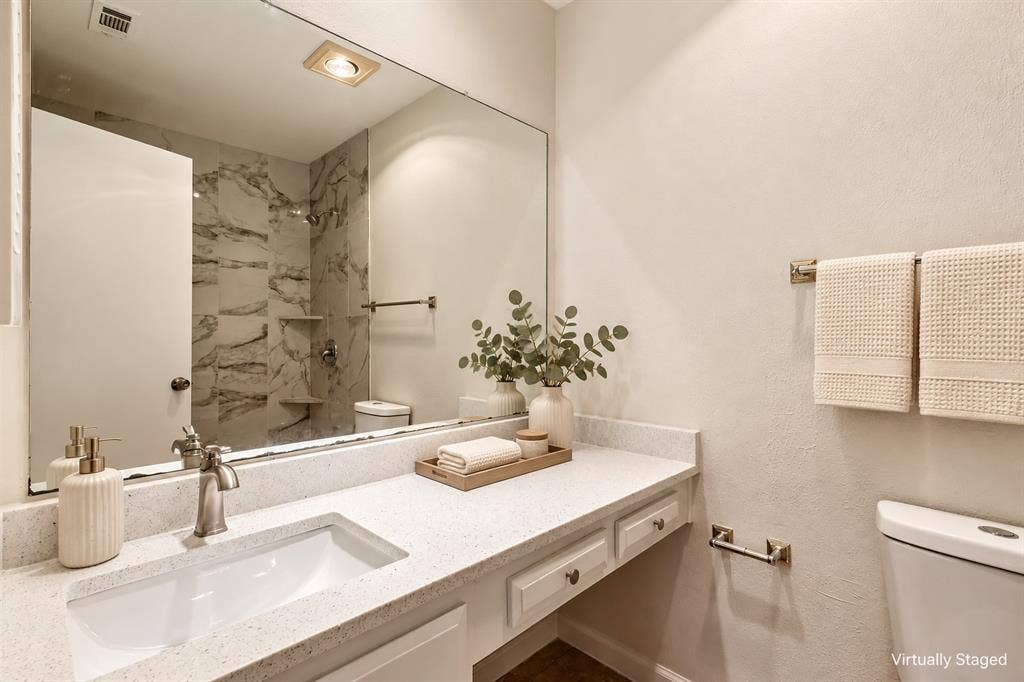 Extended vanity featuring an integrated rectangular sink and brushed nickel faucet