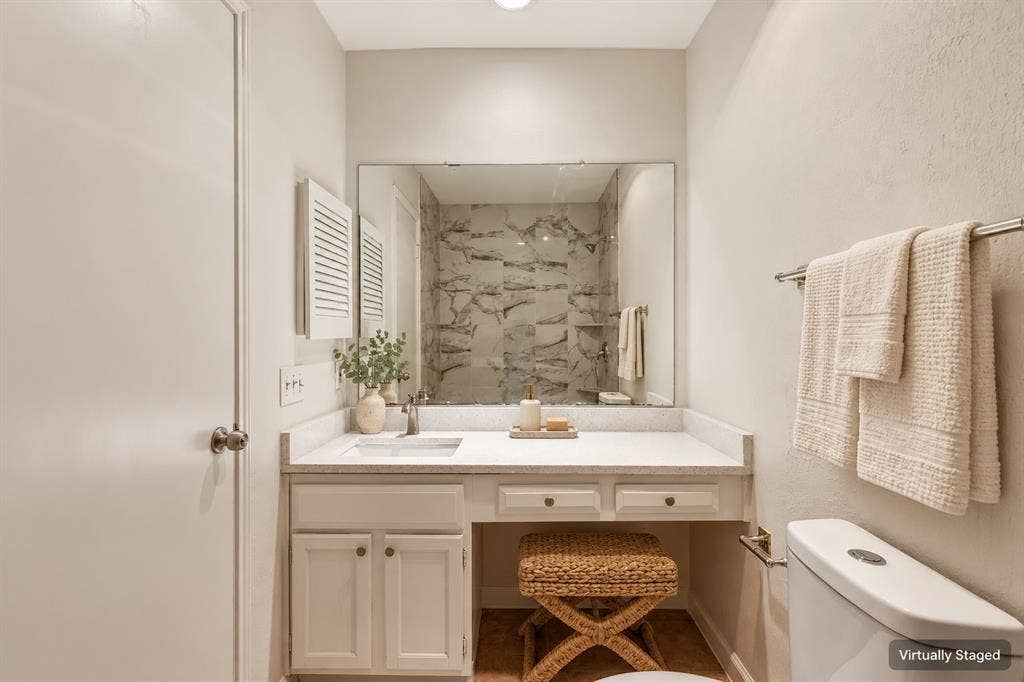 Vanity with an integrated sink, polished chrome faucet, and ample counter space