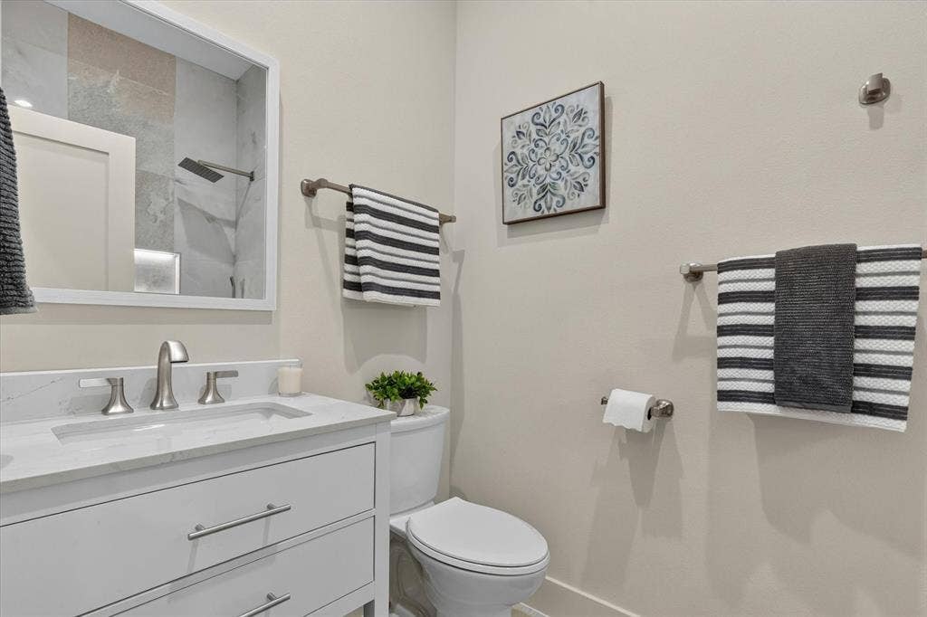3210 Carpenter Avenue, Dallas, TX 75215 White vanity with brushed nickel hardware, undermount sink, and a light-colored countertop