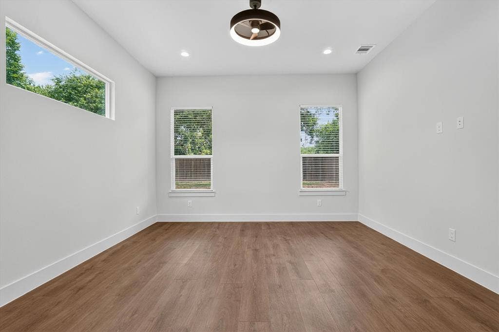 3210 Carpenter Avenue, Dallas, TX 75215 Wood-finish flooring, recessed lighting, modern ceiling fan, three windows, white walls