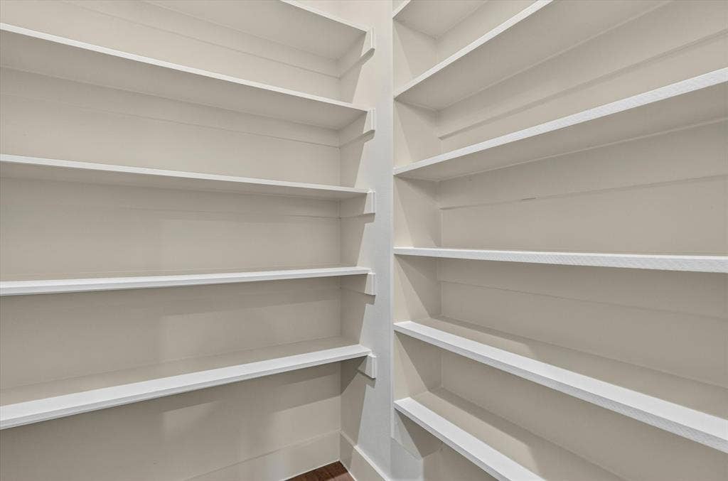 3210 Carpenter Avenue, Dallas, TX 75215 Built-in shelving with multiple white shelves and light-toned walls