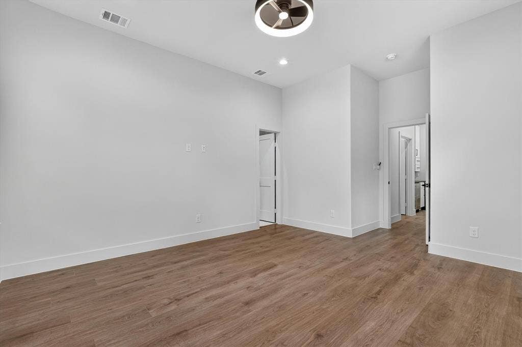 3210 Carpenter Avenue, Dallas, TX 75215 Wood-finish flooring, recessed lighting, and a modern ceiling fixture