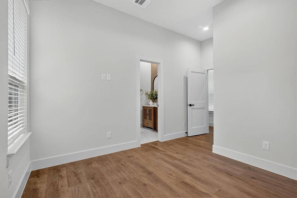 3210 Carpenter Avenue, Dallas, TX 75215 Wood-finish flooring with white baseboards, recessed lighting, and a window with blinds