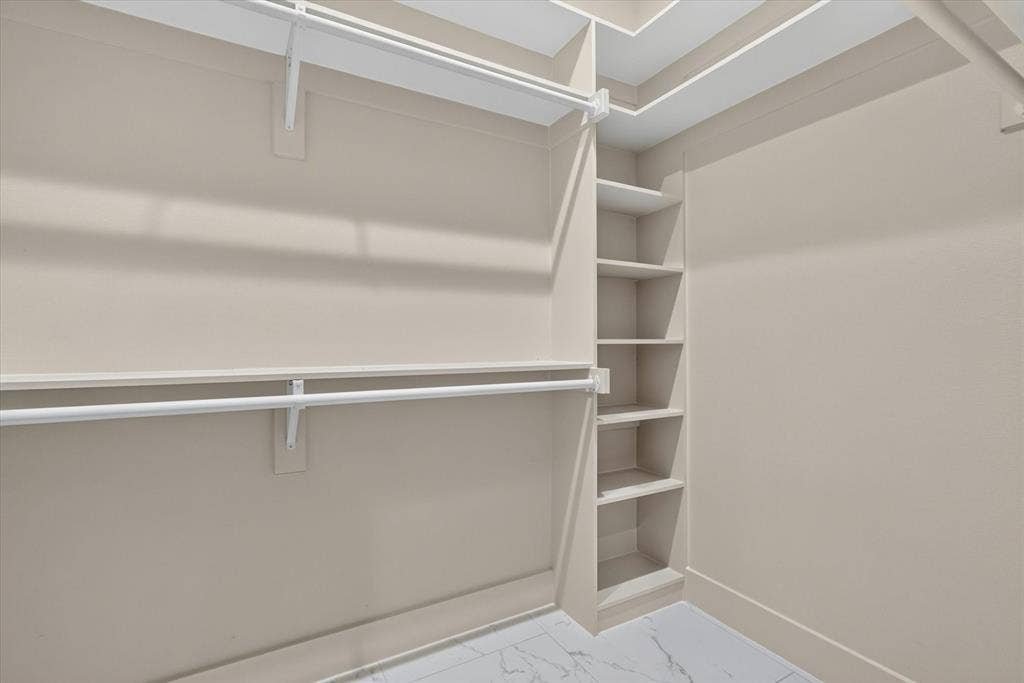 3210 Carpenter Avenue, Dallas, TX 75215 Built-in shelving, two levels of hanging rods, and light-toned walls