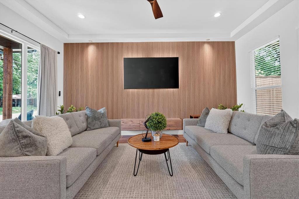 3210 Carpenter Avenue, Dallas, TX 75215 Feature wall with vertical wood paneling, recessed lighting, and a ceiling fan