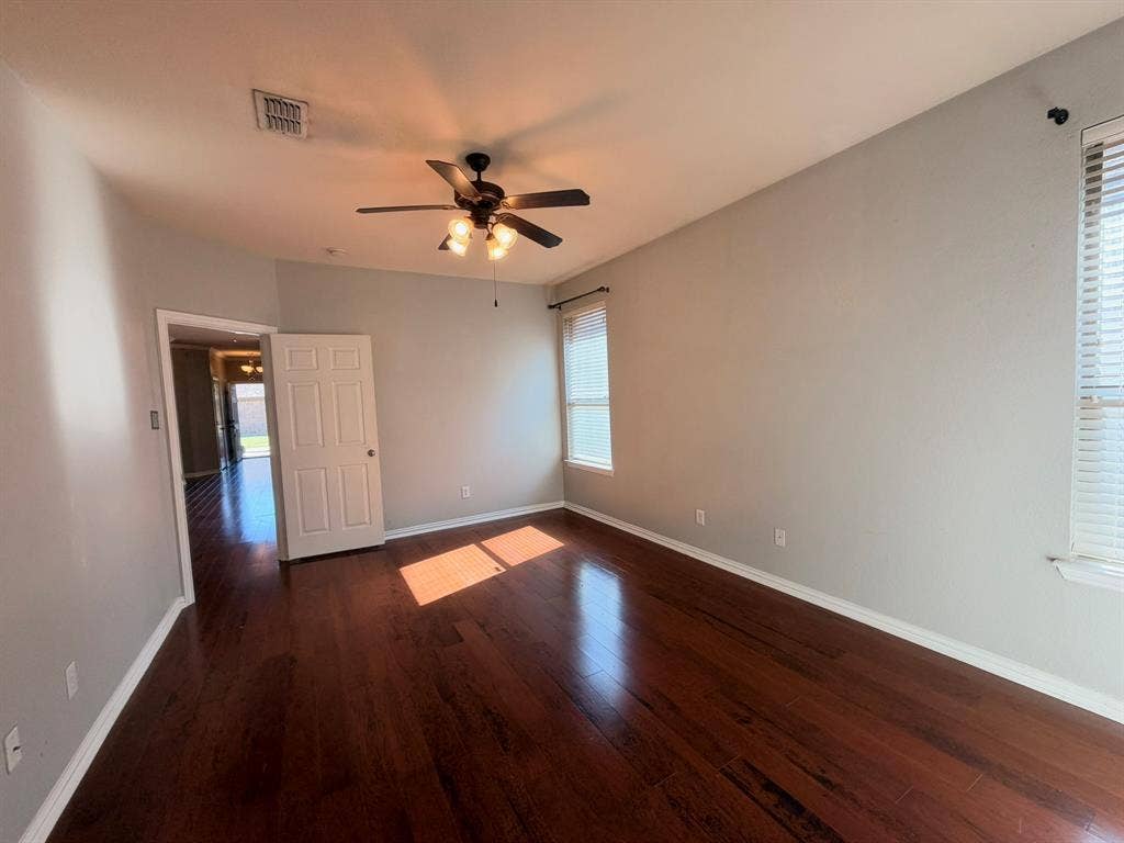 5016 Rushden Road, McKinney, TX 75070 Wood-finish flooring, ceiling fan with integrated lighting, and multiple windows
