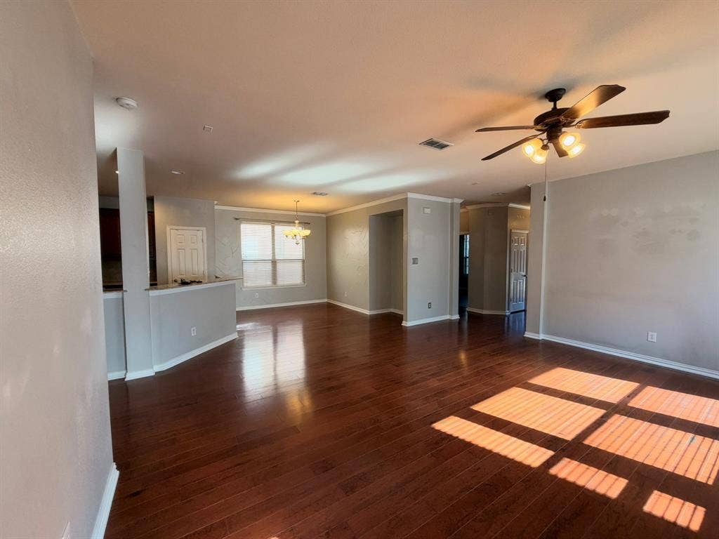 5016 Rushden Road, McKinney, TX 75070 Expansive room featuring wood-finish flooring, a ceiling fan with integrated lighting, and crown molding