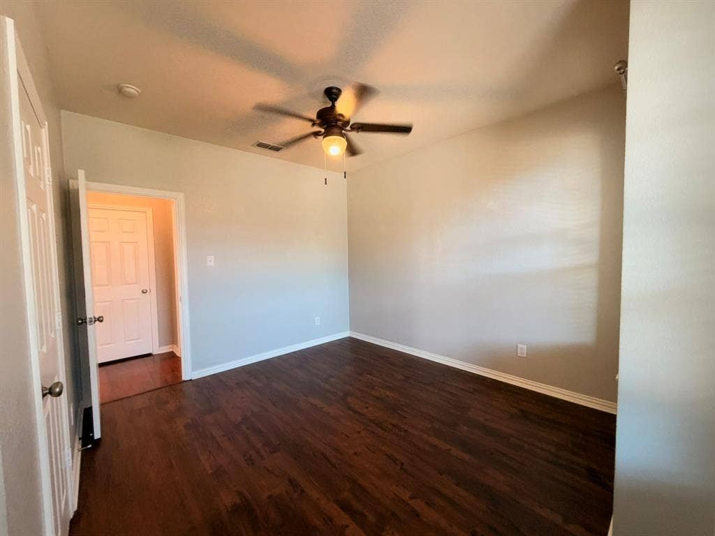 5016 Rushden Road, McKinney, TX 75070 Hardwood-finish flooring, light neutral wall paint, and a ceiling fan with integrated lighting