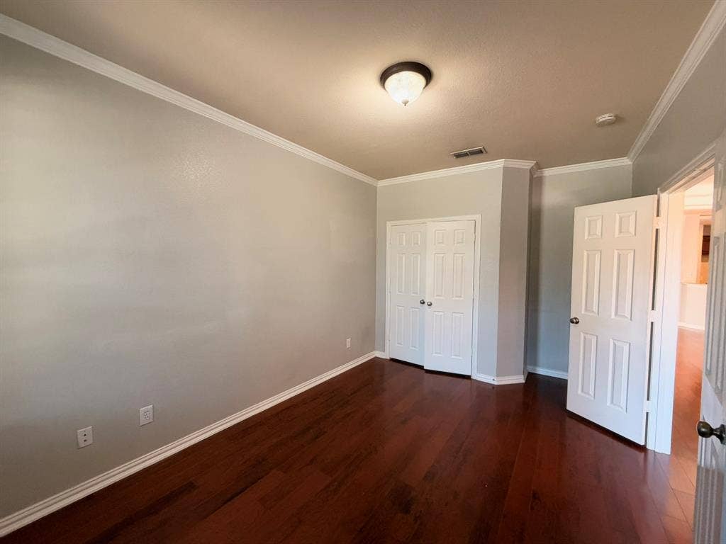 5016 Rushden Road, McKinney, TX 75070 Wood-finish flooring, crown molding, and two panel doors