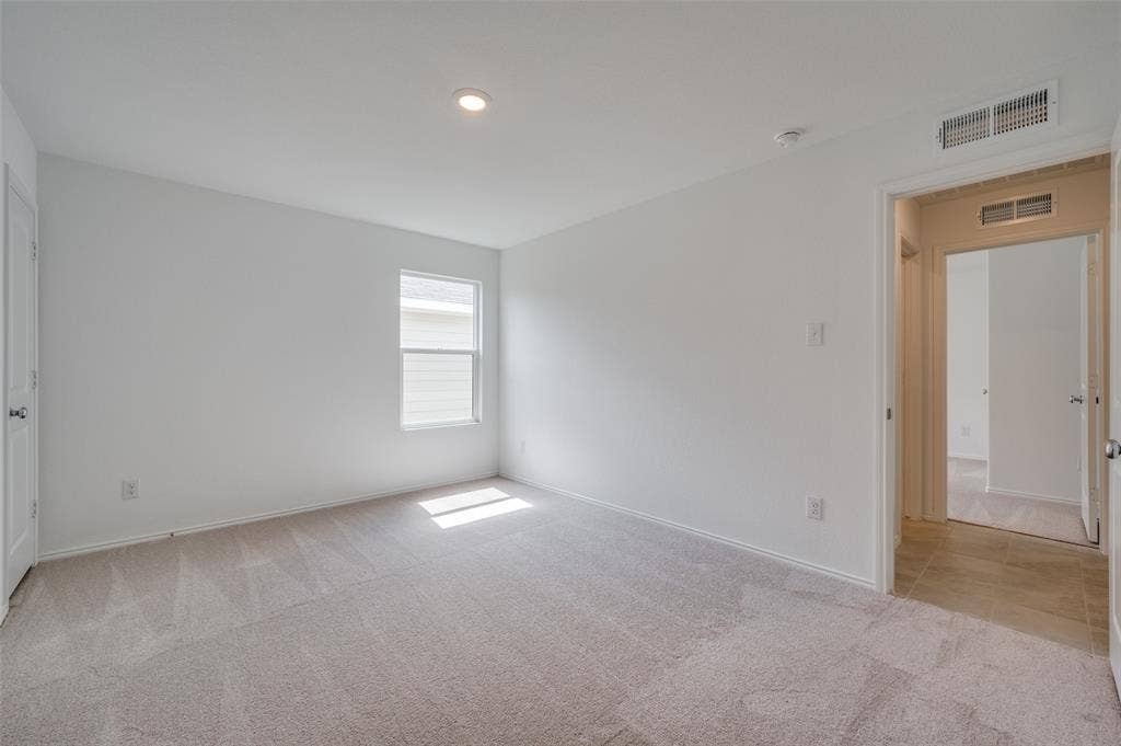 3700 Bluebird Lane, McKinney, TX 75071 Empty room featuring light colored carpet