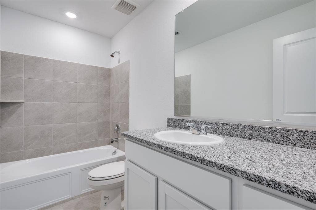3700 Bluebird Lane, McKinney, TX 75071 Full bathroom featuring tile flooring, oversized vanity, toilet, and tiled shower / bath combo