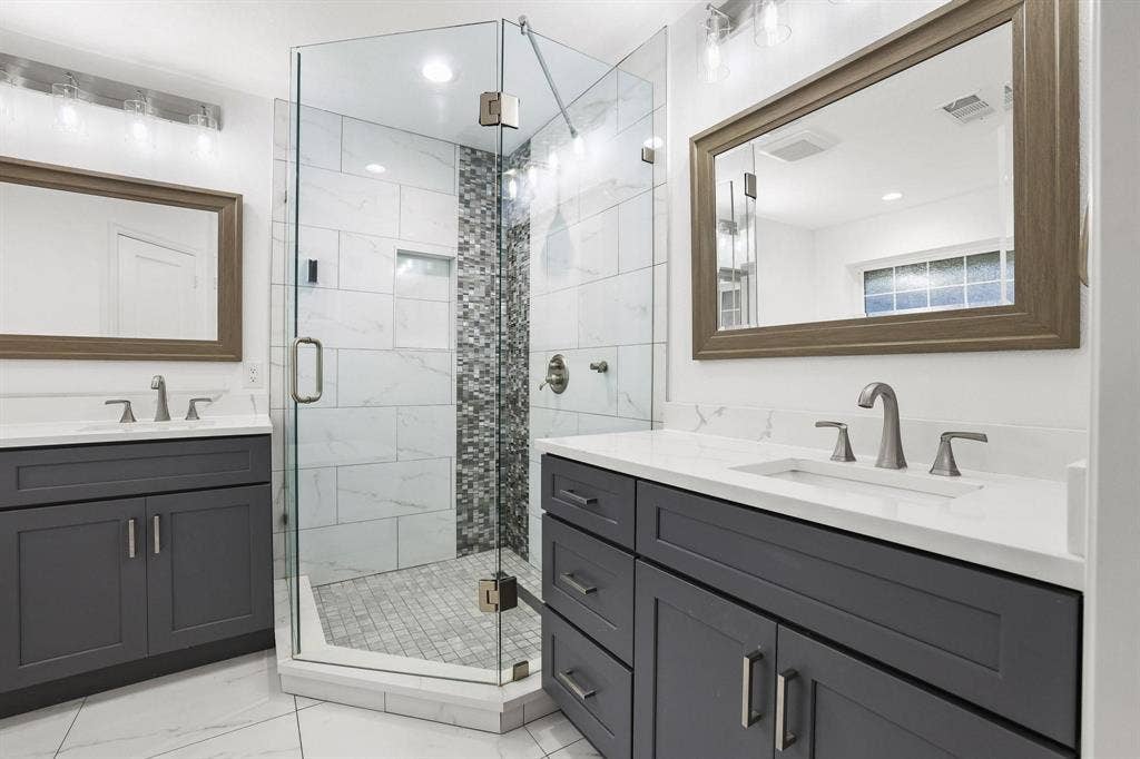 7668 La Cosa Drive, Dallas, TX 75248 Dual vanity with gray cabinetry and white countertops