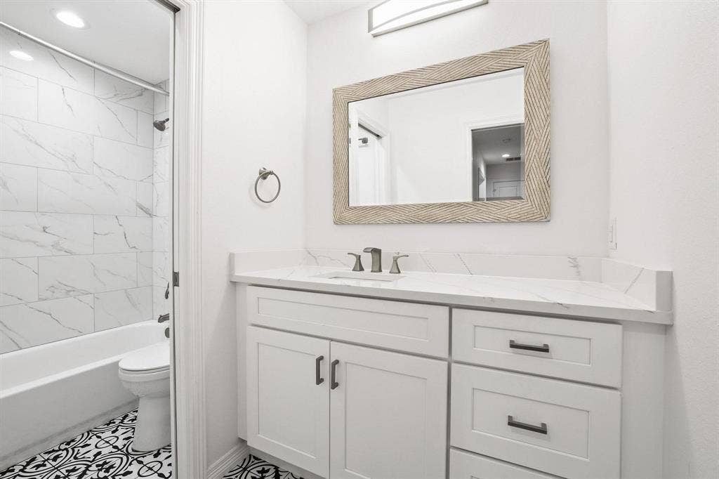 7668 La Cosa Drive, Dallas, TX 75248 Downstairs Bedroom 3, Neutral tone carpeting, white walls, ceiling fan with light, recessed lighting, and a window with a white frame