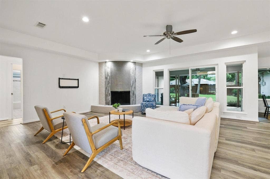 7668 La Cosa Drive, Dallas, TX 75248 Wood-finish flooring, recessed lighting, and a ceiling fan with integrated lighting