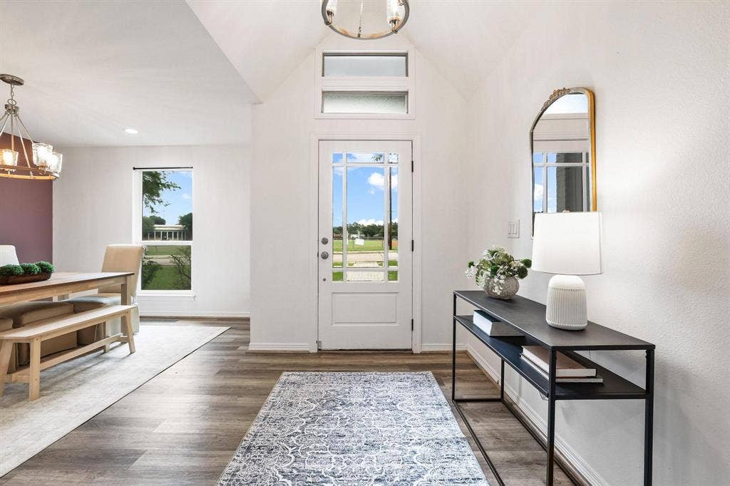 7668 La Cosa Drive, Dallas, TX 75248 Vaulted entryway with wood-finish flooring, transom windows, and a glass-paneled entry door