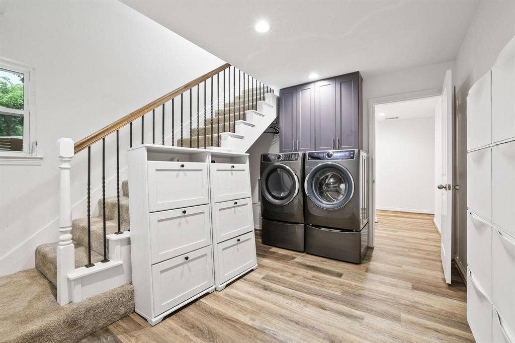 7668 La Cosa Drive, Dallas, TX 75248 Laundry area featuring stacked washer and dryer, upper cabinetry, and wood-finish flooring