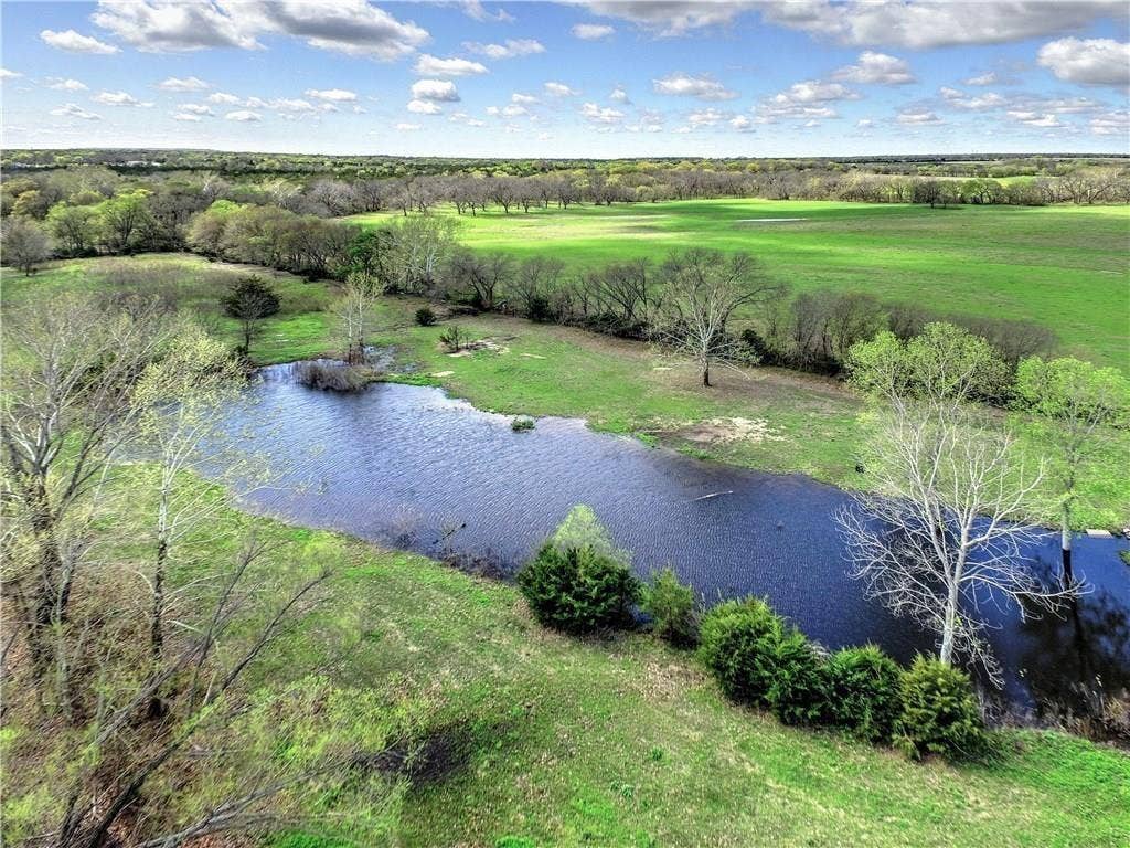 12875 Westover Lane, Anna, TX 75409 Expansive green pastures and mature trees surround a tranquil pond